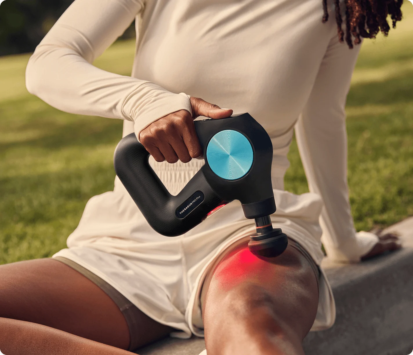 Athlete using the Theragun PRO Plus outdoors